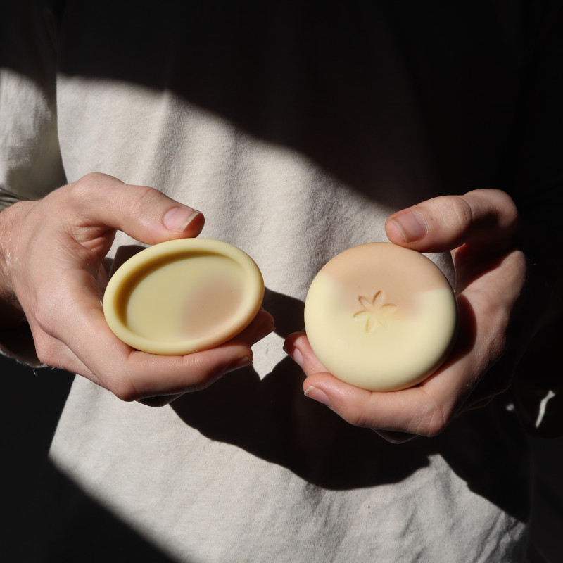 hands holding oval and big round pink clay soap